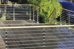 Great photo of how clean the look is using modern rod railing on a deck
