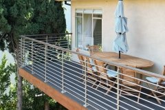 Metal deck rail with wood top rail.